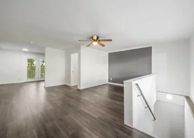 Living room featuring large natural-light windows inside the Kingwood 2 bedroom floor plan at Hillwood Villas.